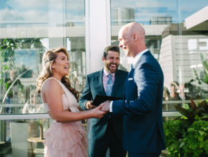 wedding officiant and couple laughing